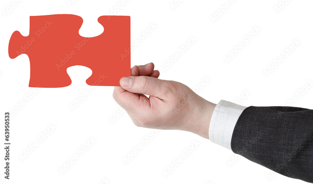 male hand with red puzzle piece male hand with red puzzle piece