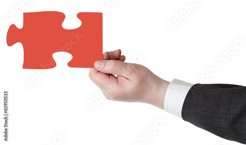 Foto male hand with red puzzle piece