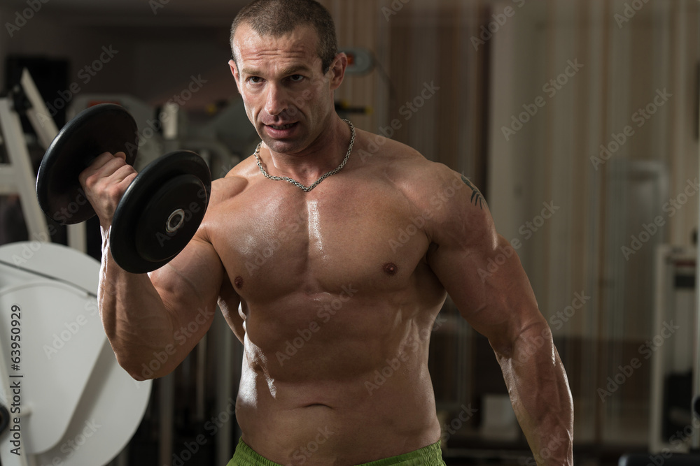Young Man Working Out In A Health Club