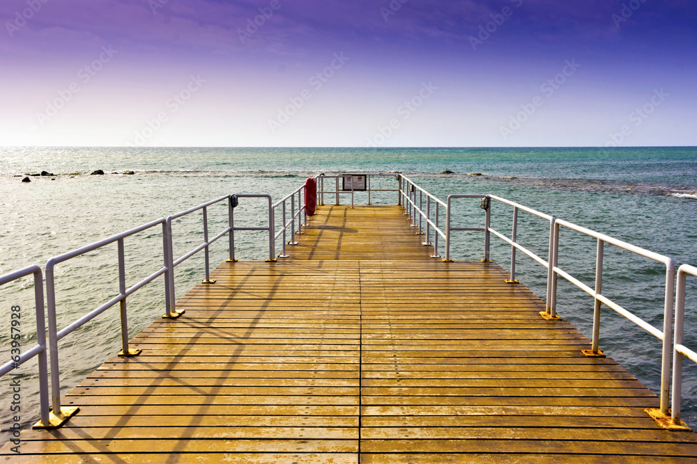 Wooden jetty with metal railings.