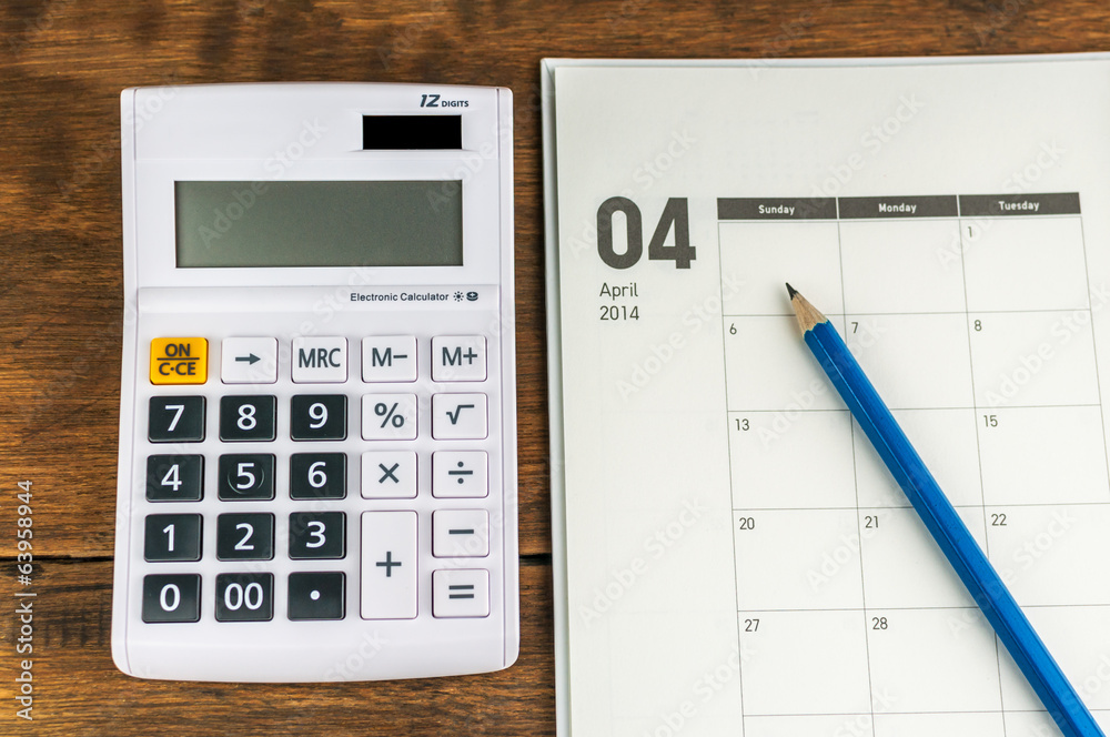 April organizer with calculator & pencil: concept for monthly bu April organizer with calculator & pencil: concept for monthly bu