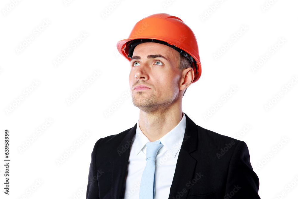 confident businessman in helmet looking up confident businessman in helmet looking up