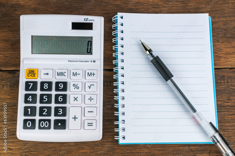 Calculator with notebook & pen on wooden background Calculator with notebook & pen on wooden background
