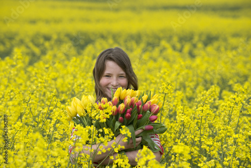 Young girl holding a bunch of Spring flowers