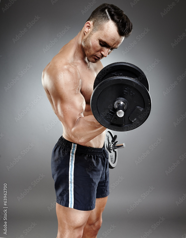 Athletic man working out with dumbbells