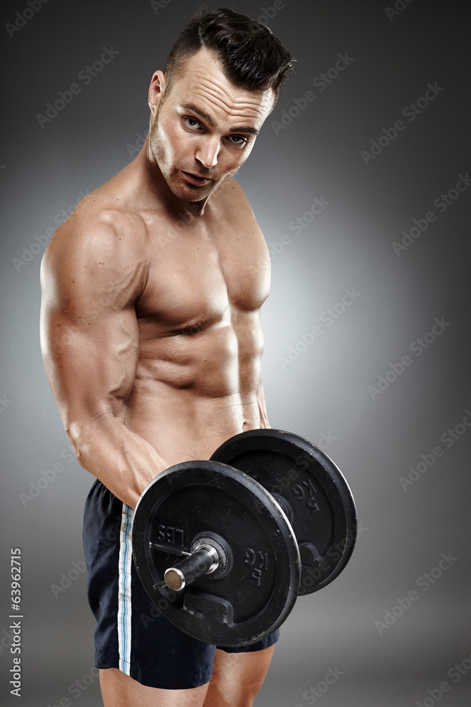 Athletic man working out with dumbbells