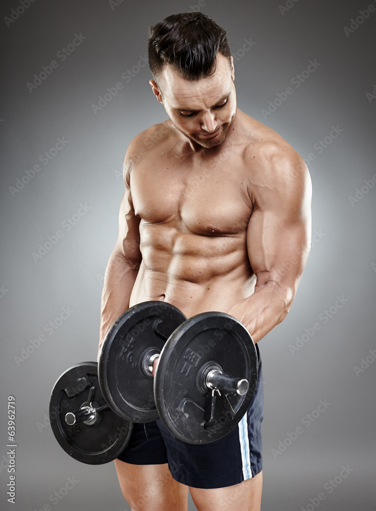 Athletic man working out with dumbbells