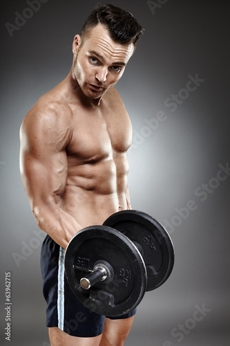 Athletic man working out with dumbbells