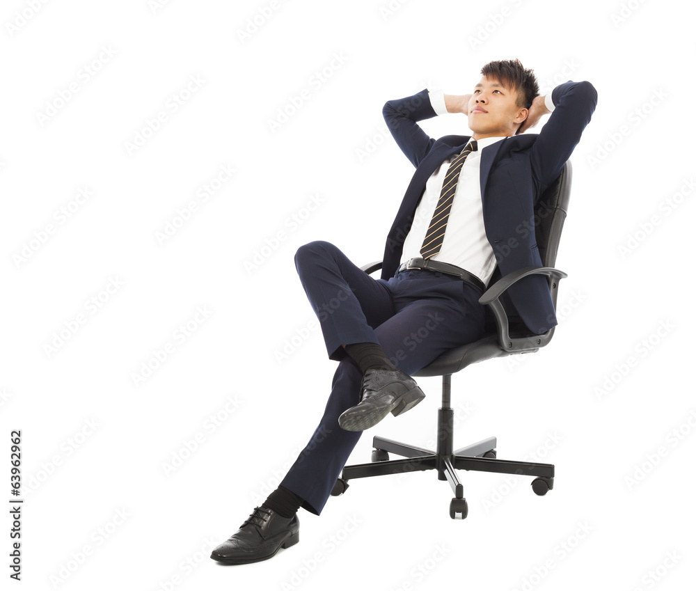 young businessman sitting on a chair and thinking young businessman sitting on a chair and thinking