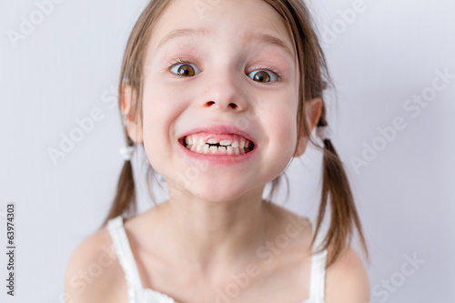 Close up portrait of preschooler girl with wide smile photo