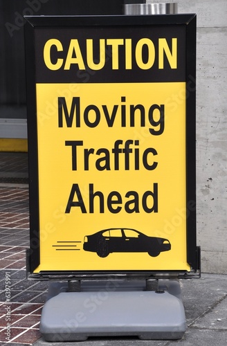 Caution moving traffic ahead signage