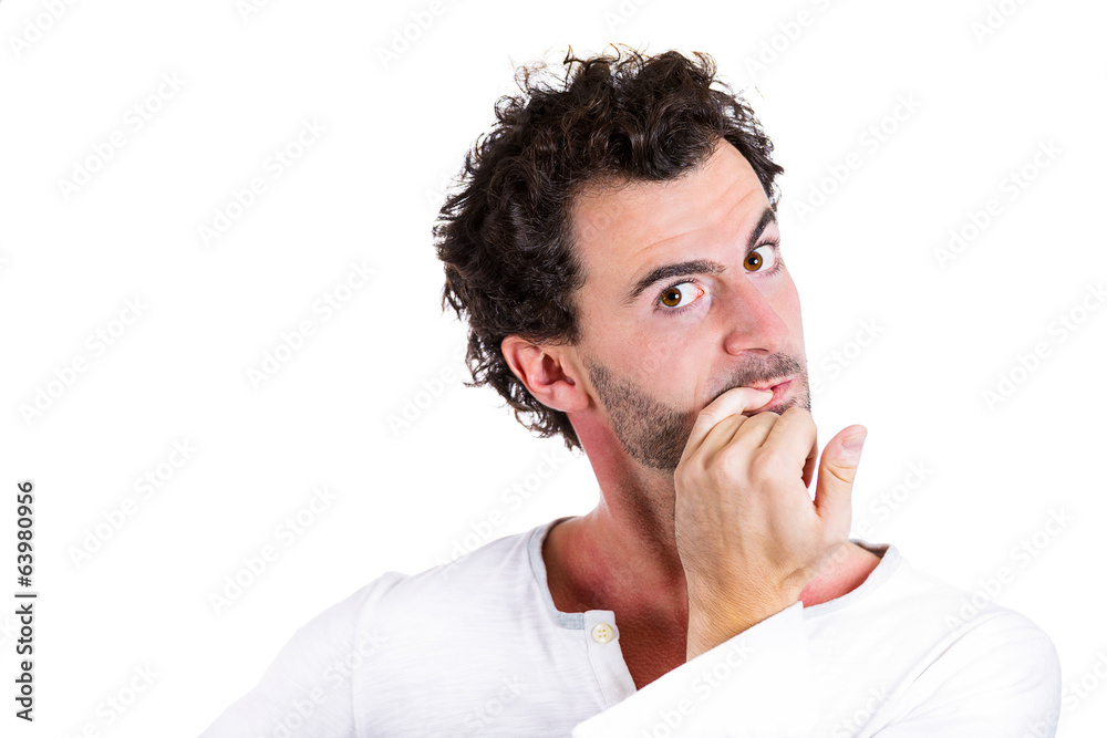 Anxious, scared young man nervously biting fingernails Anxious, scared young man nervously biting fingernails