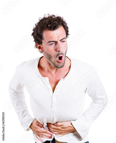 Young man having severe abdominal, stomach pain