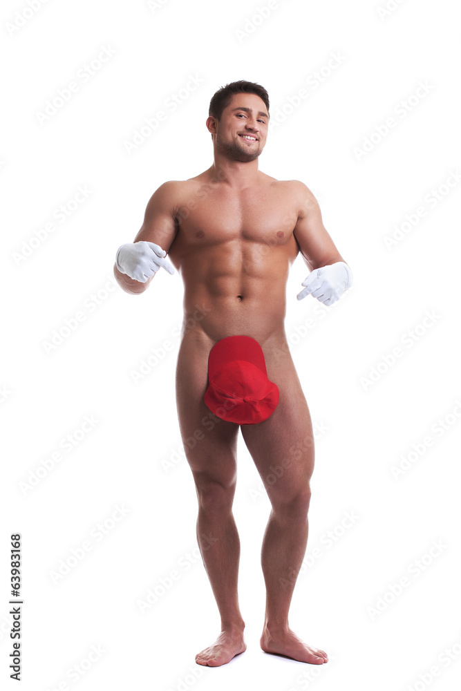 Studio shot of happy naked man posing at camera Studio shot of happy naked man posing at camera