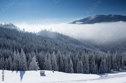 Winter mountain landscape with blue sky and white clouds