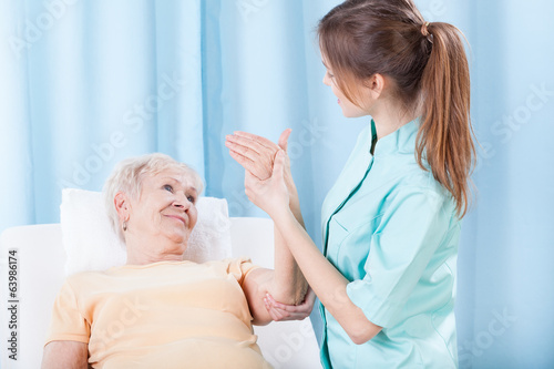 Elderly women having arm examination