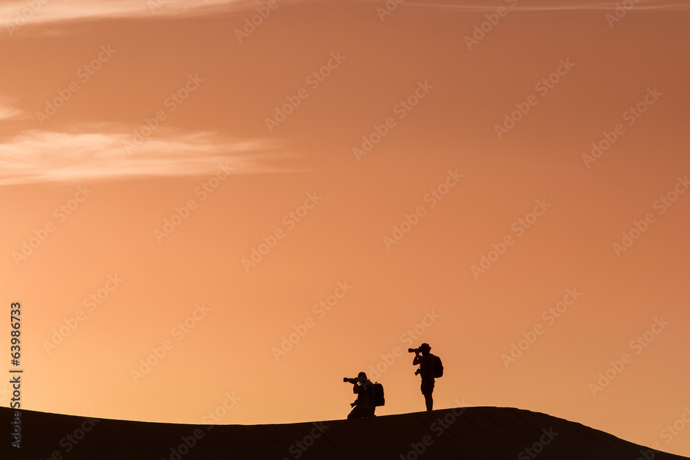 Silhouette of photographers in desert Sahara, Morocco