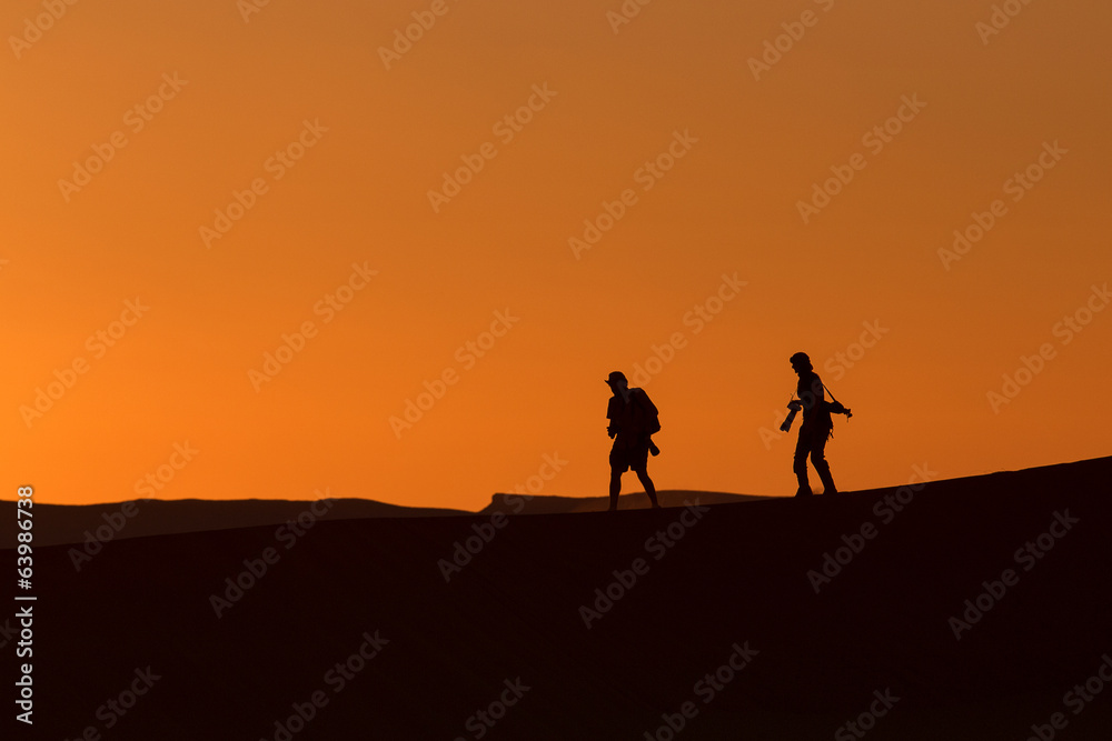 Silhouette of photographers in desert Sahara, Morocco