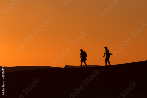 Silhouette of photographers in desert Sahara, Morocco