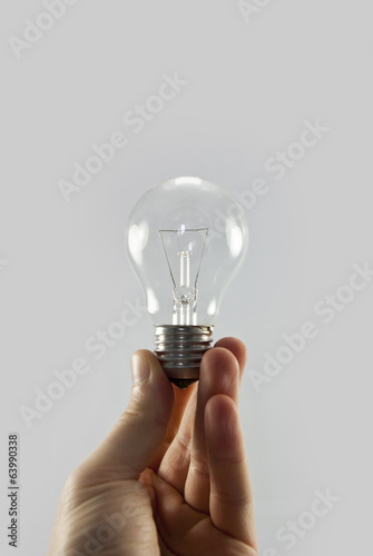 holding light bulb isolated on white background