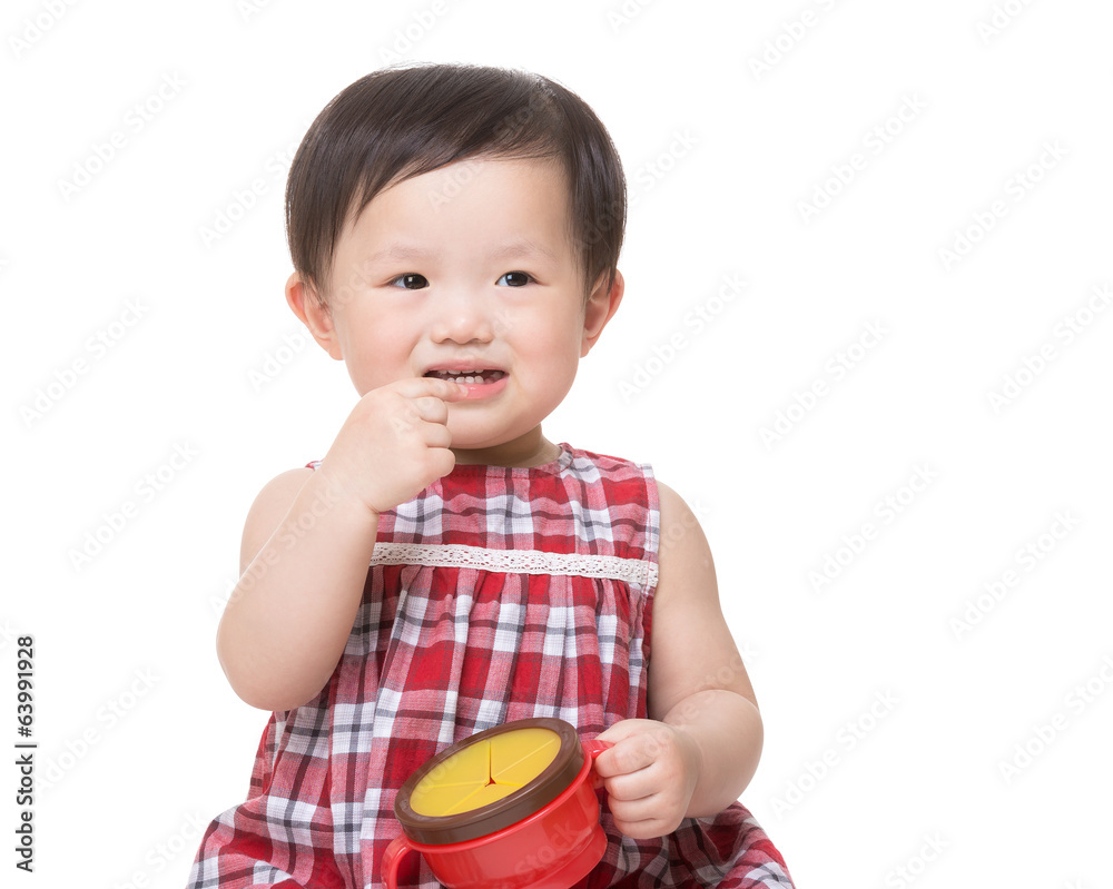 Asia little girl eating snack and holding food box Asia little girl eating snack and holding food box