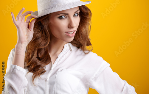 Fashion portrait of pretty woman wearing stylish hat. Young Cauc