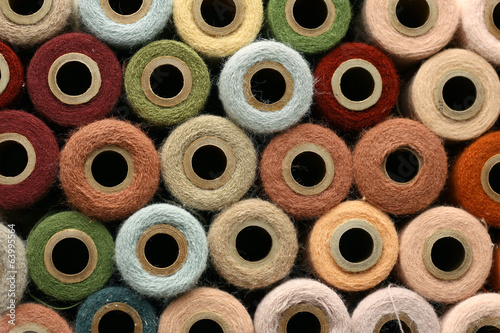 Collection of Natural Colored Vintage Yarn Spools Background