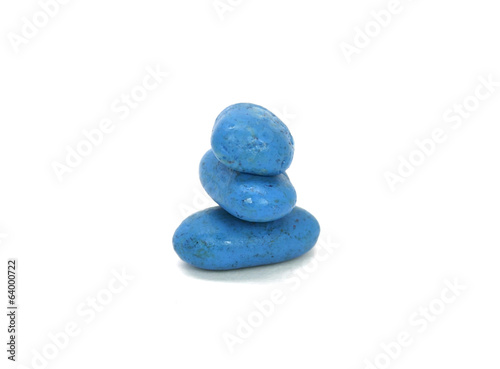 Stack of colored pebble stones on white background