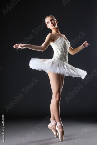 Image of cute young ballerina dancing in studio