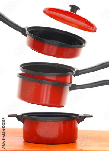 Red cookware set on white background photo