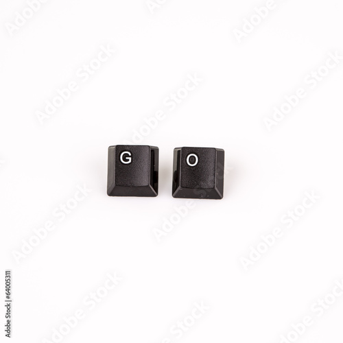 go word written with black computer buttons over white photo