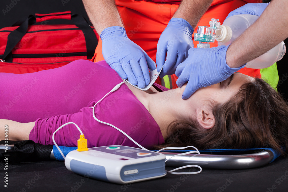 Fotografie Paramedics using defibrillator on a patient