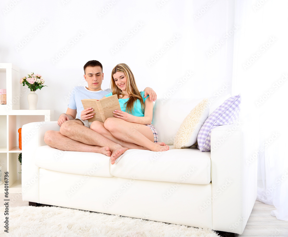Beautiful couple reading on sofa Beautiful couple reading on sofa