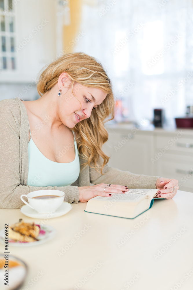 woman drinking coffee and reading book woman drinking coffee and reading book