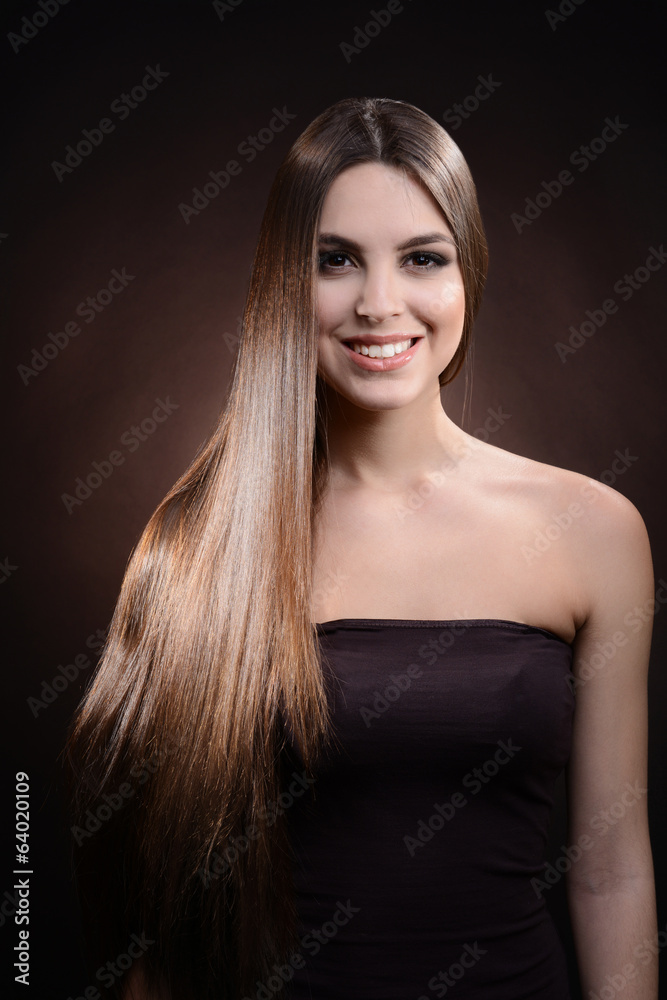 Beautiful young woman with long hair on dark brown background Beautiful young woman with long hair on dark brown background