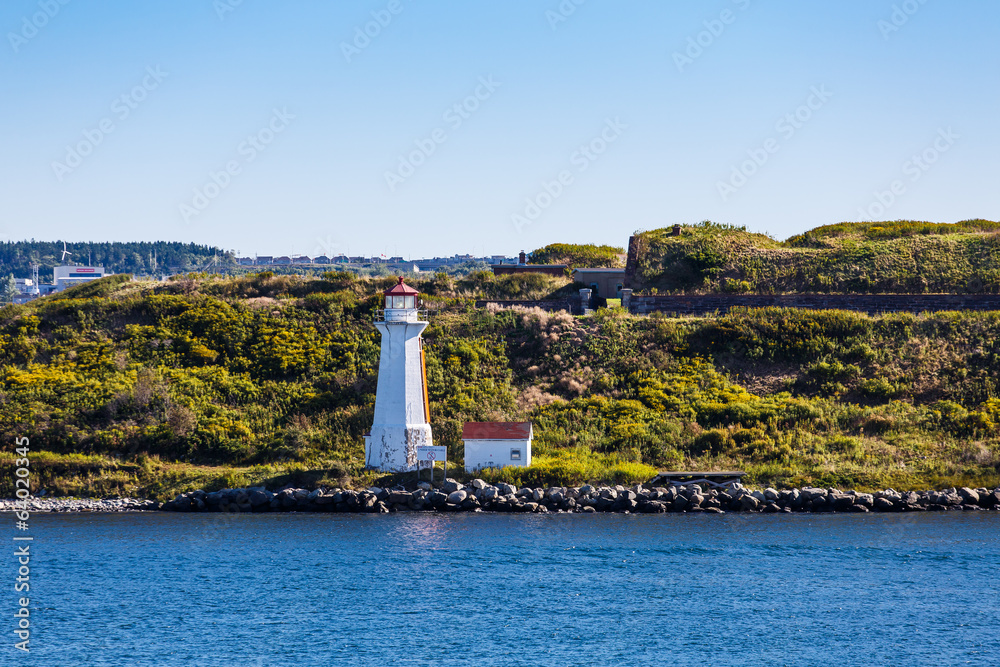 White Lighthouse on Green Grassy Coast