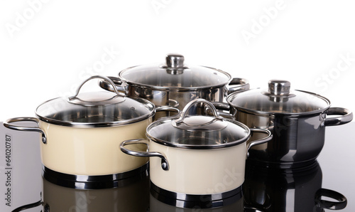 Pans on table on white background
