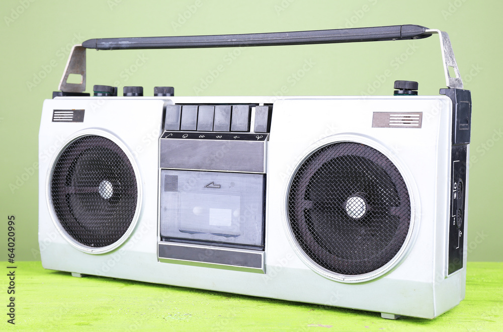 Retro cassette stereo recorder on table on green background Retro cassette stereo recorder on table on green background