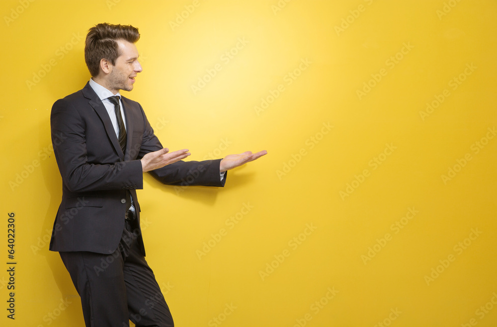 Handsome brunette businessman indicates something Handsome brunette businessman indicates something