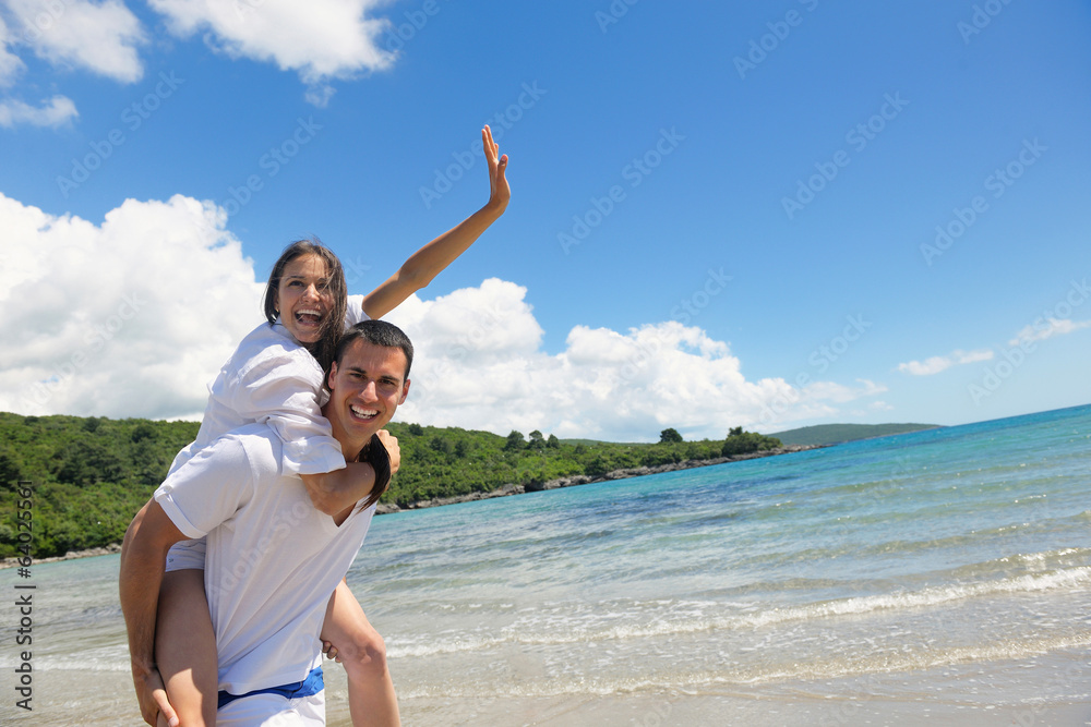 happy couple have fun on the beach happy couple have fun on the beach