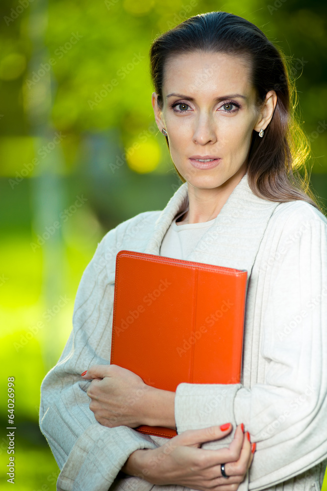 Portrait of smiling business woman with paper folder. Student Portrait of smiling business woman with paper folder. Student