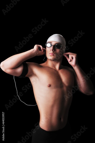 Male swimmer isolated on black