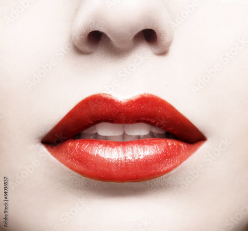 Close up of red glossy female lips