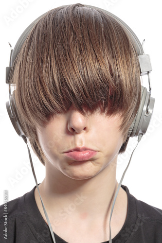 Canvas Print sulking cute teenager boy with hair over his eyes and headphones