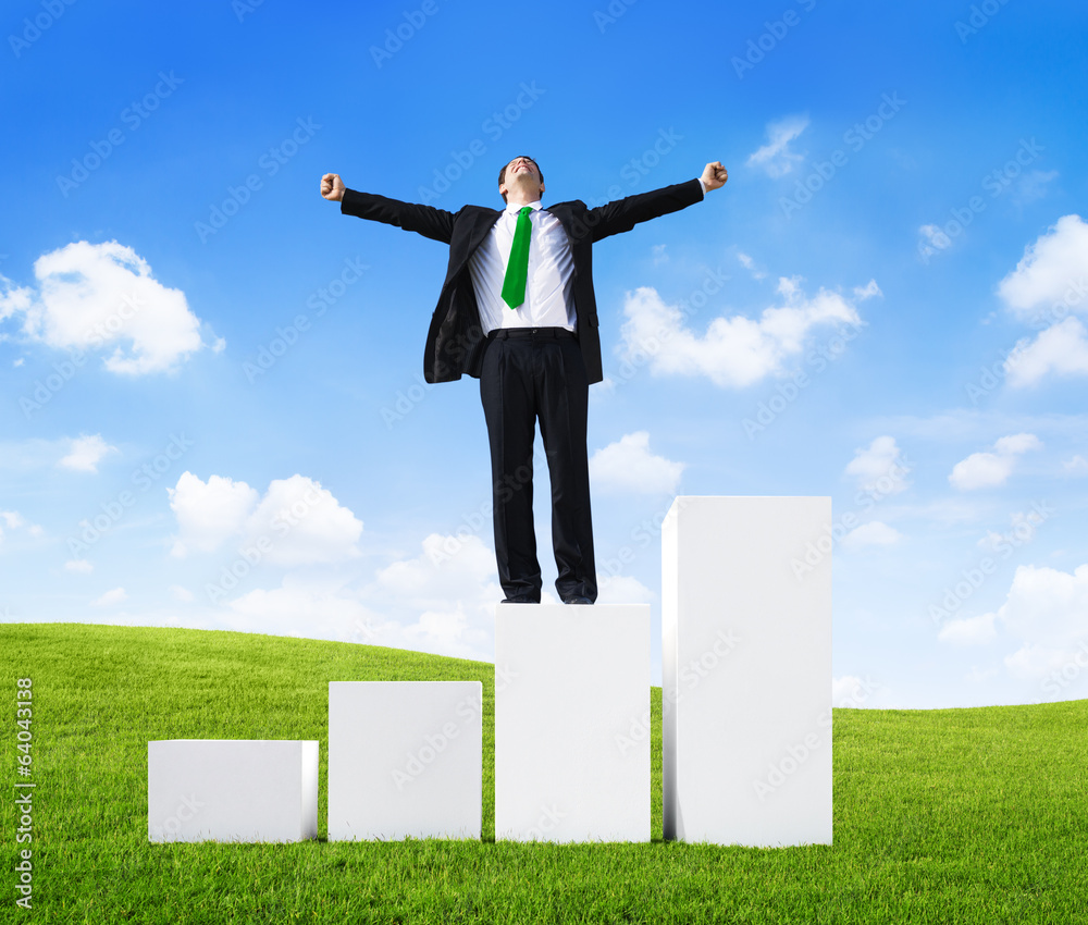 Green Businessman Celebrating on a Bar Graph Green Businessman Celebrating on a Bar Graph