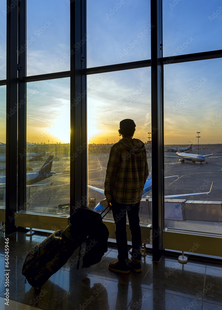 Silhouette of man near window in airport