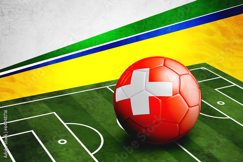 Soccer ball with Switzerland flag on pitch