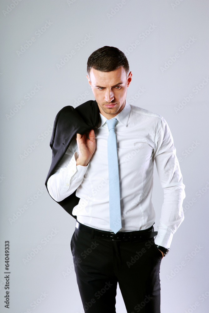 Pensive business man holding jacket on shoulder Pensive business man holding jacket on shoulder