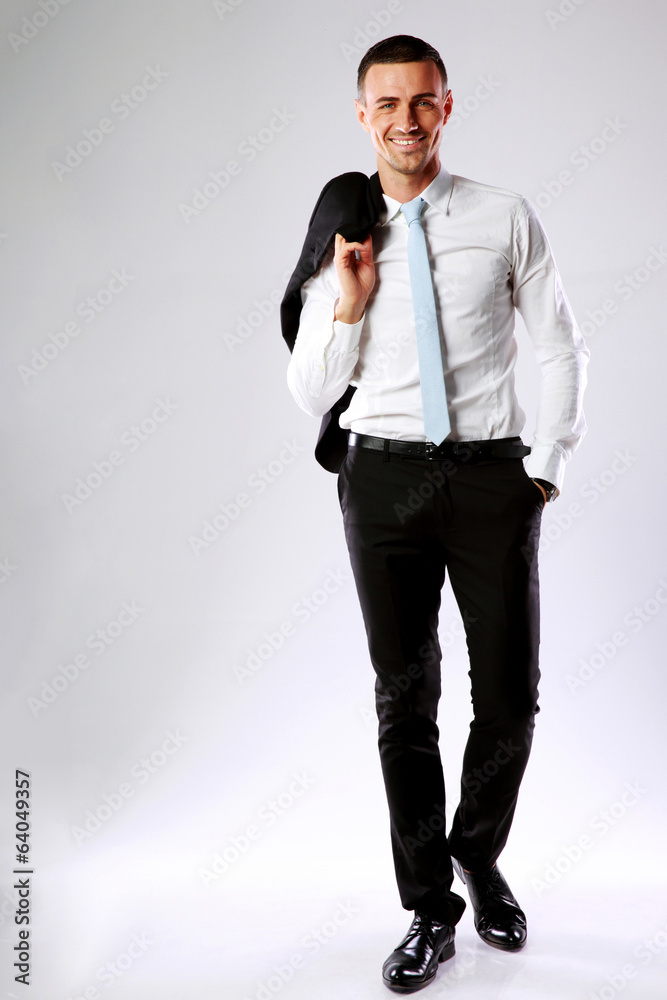 happy business man holding jacket on shoulder happy business man holding jacket on shoulder