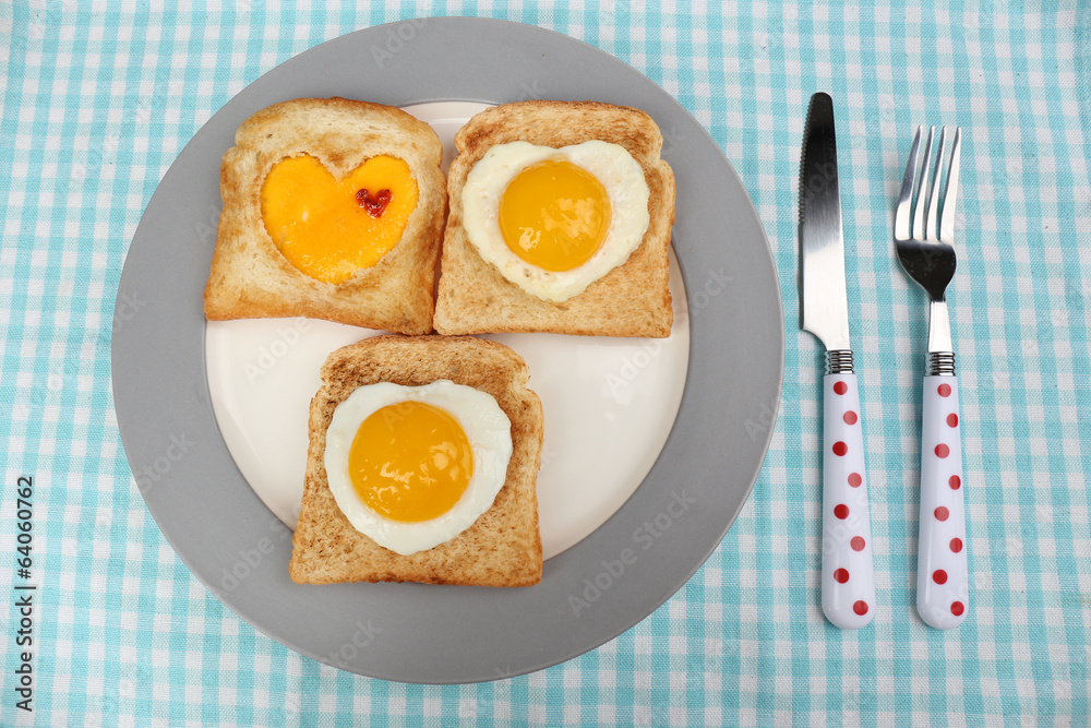 Scrambled eggs with bread on plate, on color napkin Scrambled eggs with bread on plate, on color napkin